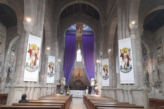 Inside a Braga cathedral adorned with purple banners, capturing the essence of Easter celebrations in Portugal.