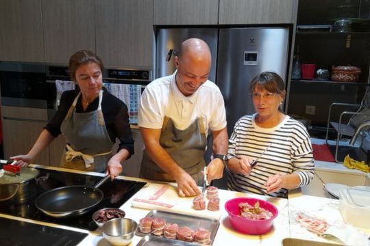 In a vibrant kitchen, two Portuguese chefs create delicious dishes, setting the stage for an unforgettable dinner experience in Portugal.