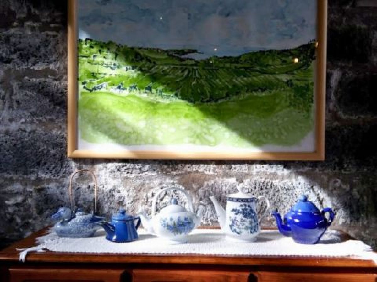 A vibrant painting featuring a vase and teapot, showcasing the charm of Azores factory tea tours.