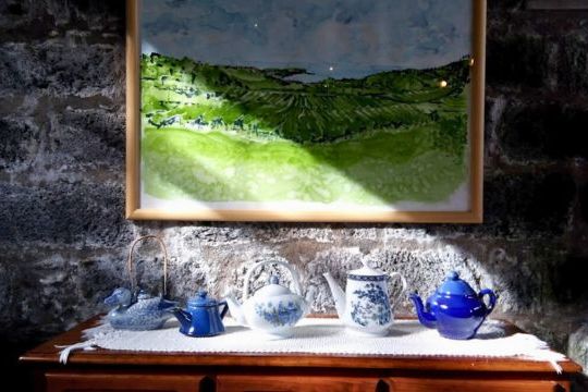 A vibrant painting featuring a vase and teapot, showcasing the charm of Azores factory tea tours.