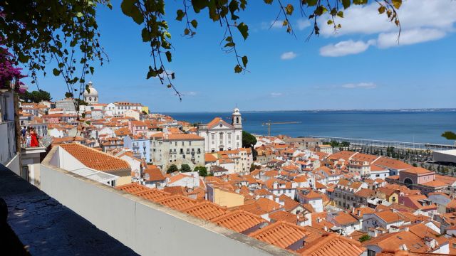 A panoramic view of Lisbon, Portugal, showcasing vibrant city life and charming architecture on an affordable small group tour.