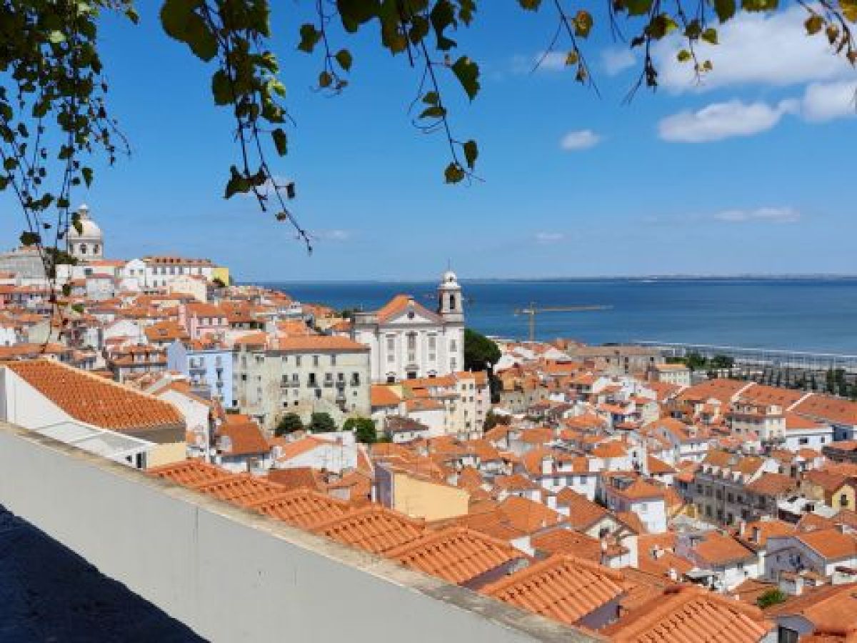 A panoramic view of Lisbon, Portugal, showcasing vibrant city life and charming architecture on an affordable small group tour.