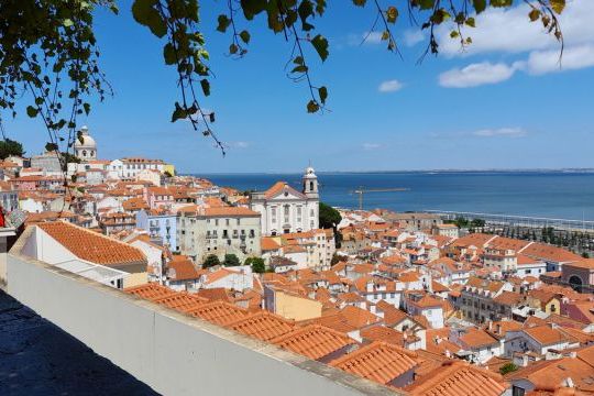 A panoramic view of Lisbon, Portugal, showcasing vibrant city life and charming architecture on an affordable small group tour.