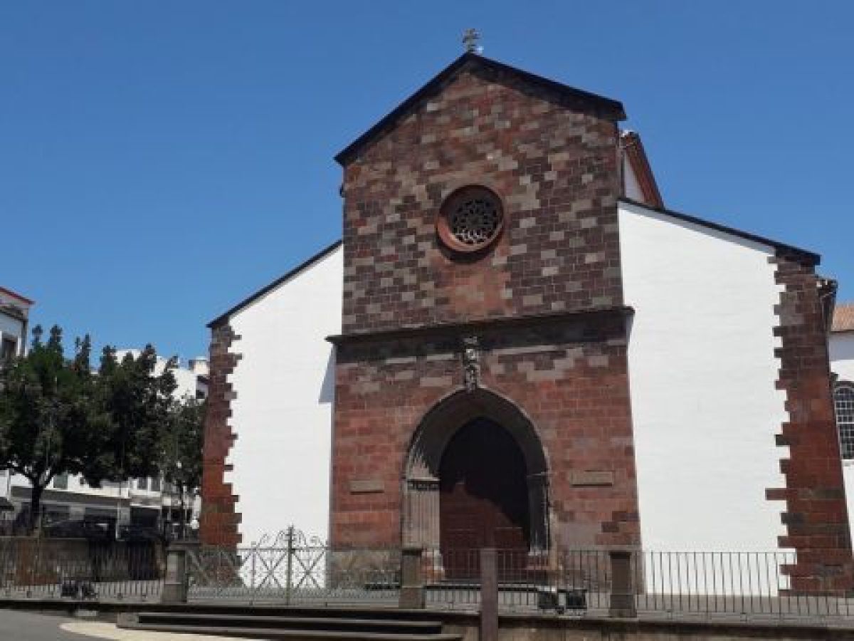 A stunning church with prominent clock tower, showcasing the charm of Madeira Highlights Adventure City.