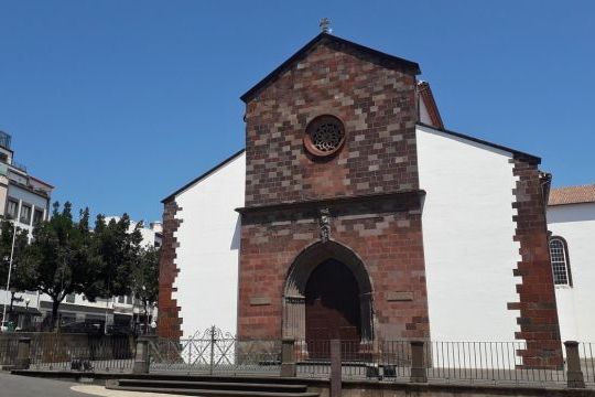 A stunning church with prominent clock tower, showcasing the charm of Madeira Highlights Adventure City.