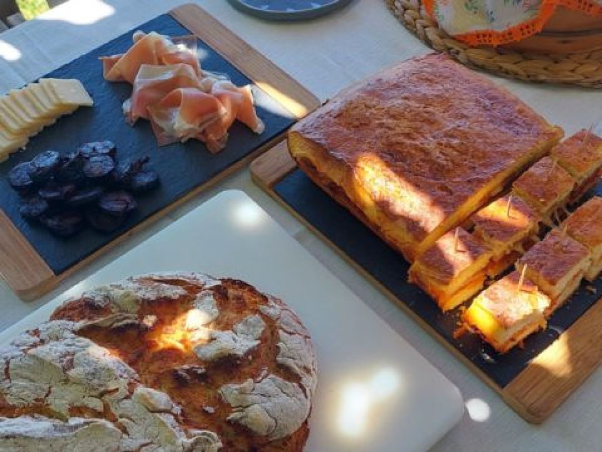 A beautifully set table showcasing Portugal's hidden culinary gems, featuring delicious food and exquisite local wines.