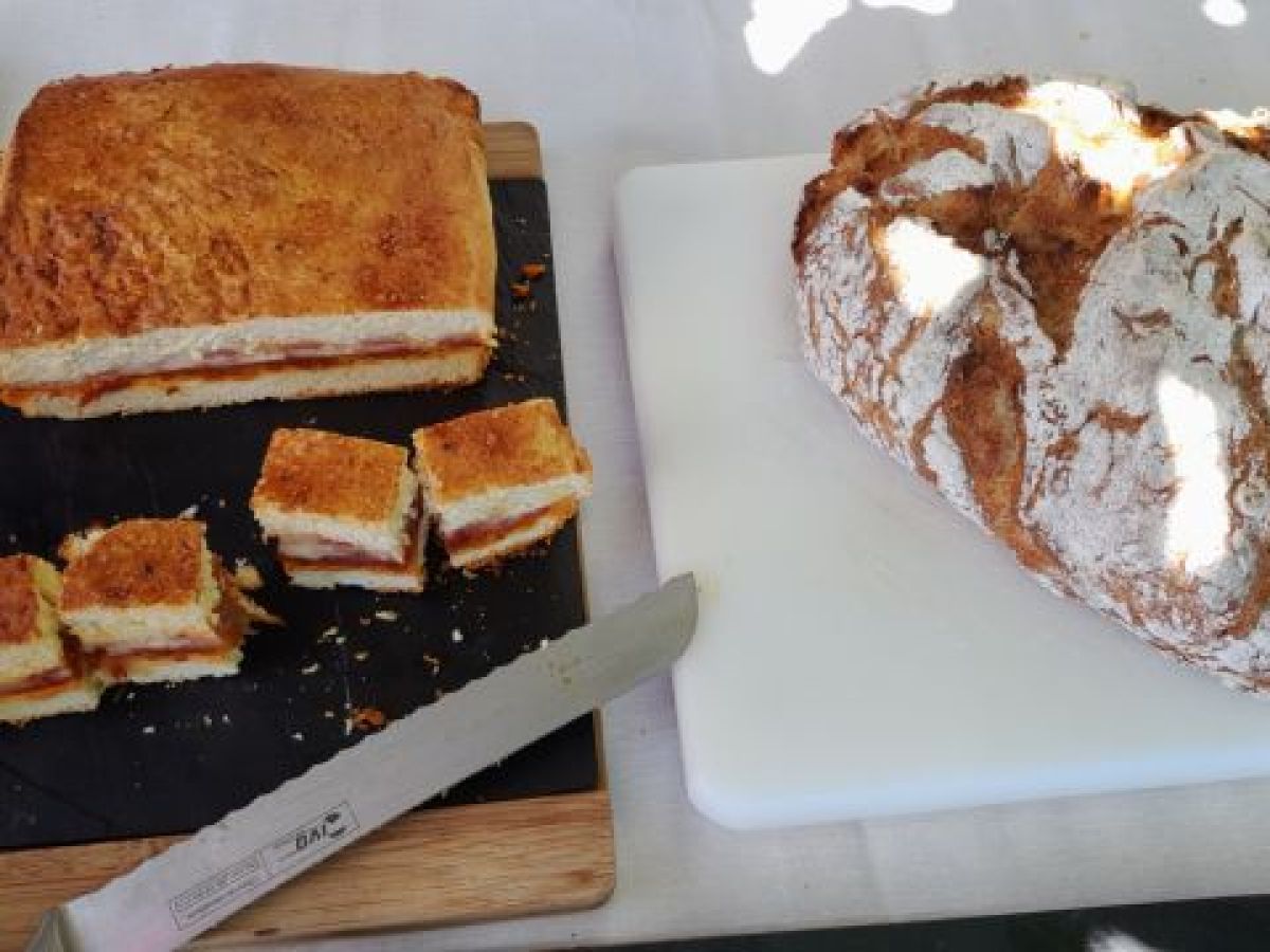 A picturesque table in the heart of Portugal's countryside, adorned with a knife and a loaf of bread, celebrating local culinary traditions.