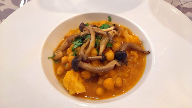 A beautifully plated dish accompanied by a spoon and fork, showcasing Lisbon's vibrant culinary scene on a food and wine tour.