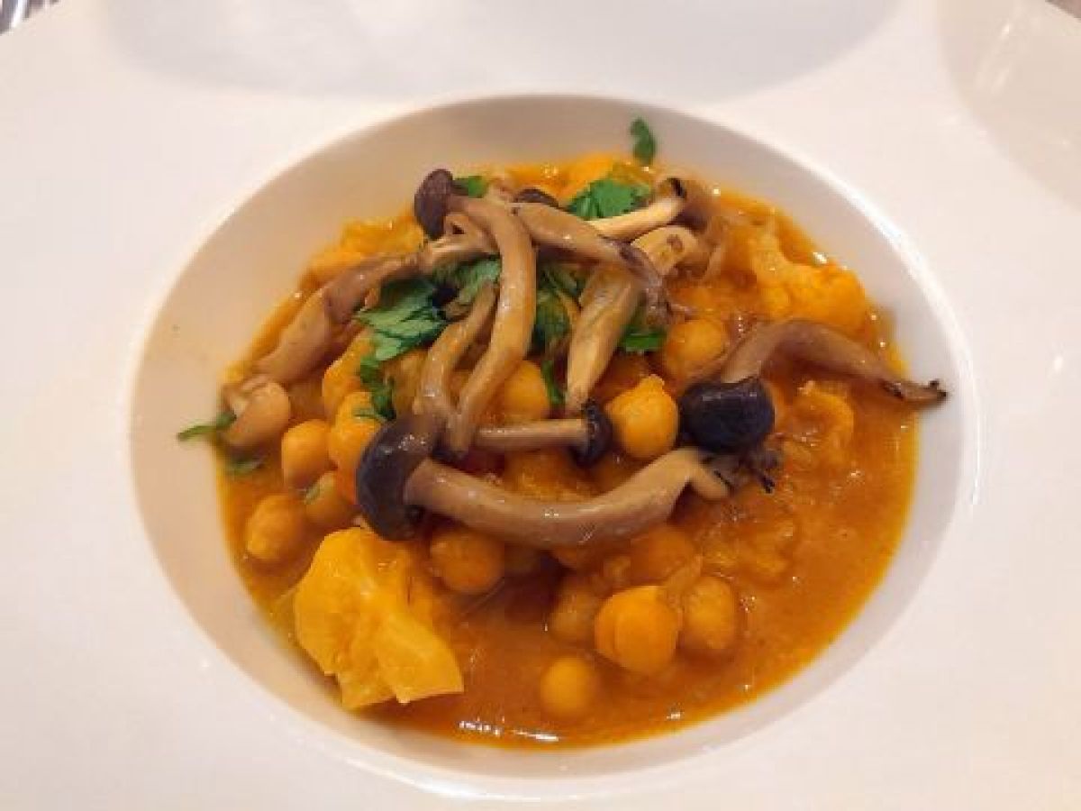 A beautifully plated dish accompanied by a spoon and fork, showcasing Lisbon's vibrant culinary scene on a food and wine tour.