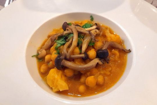 A beautifully plated dish accompanied by a spoon and fork, showcasing Lisbon's vibrant culinary scene on a food and wine tour.