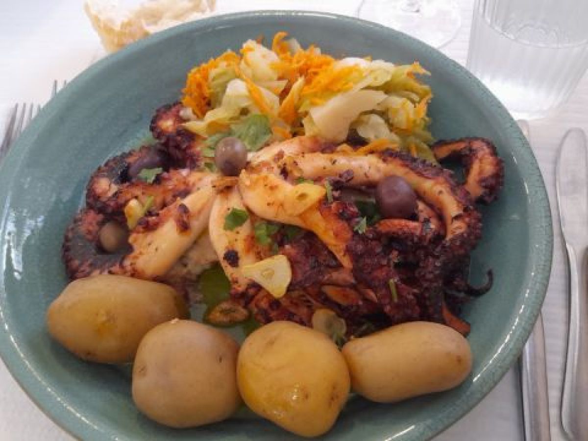 A delicious serving of octopus with potatoes and cabbage, highlighting the flavors of a Portuguese food tour.