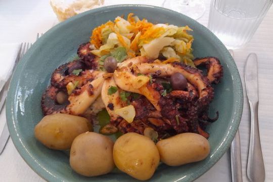 A delicious serving of octopus with potatoes and cabbage, highlighting the flavors of a Portuguese food tour.