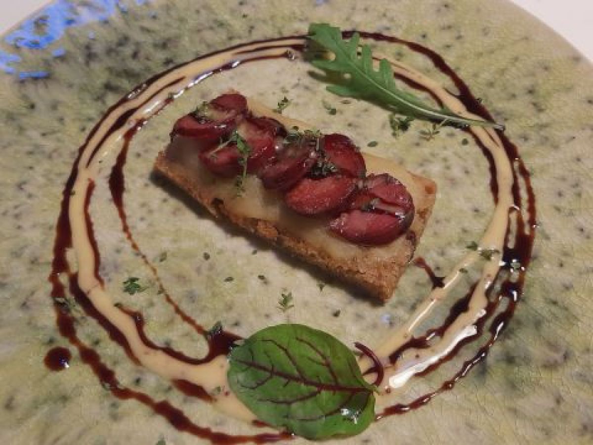 A delicious slice of bread with sauce on a plate, highlighting the flavors of Lisbon during a food and wine tour.