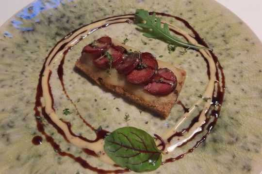 A delicious slice of bread with sauce on a plate, highlighting the flavors of Lisbon during a food and wine tour.