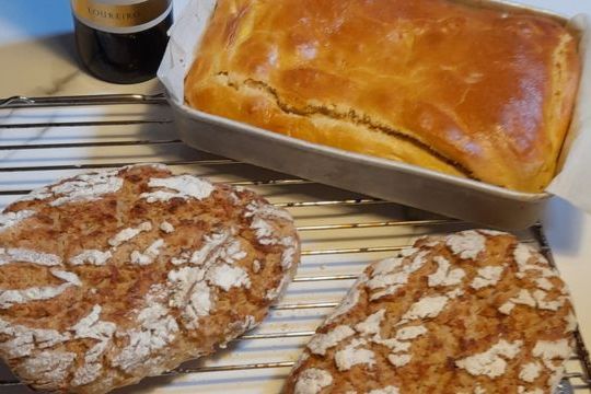 Cornbread and chorizo bread rest on a cooling rack, invitingly prepared for a wine tasting on a Lisbon food tour.