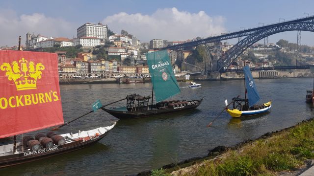 a bridge over a river with a boat in the water