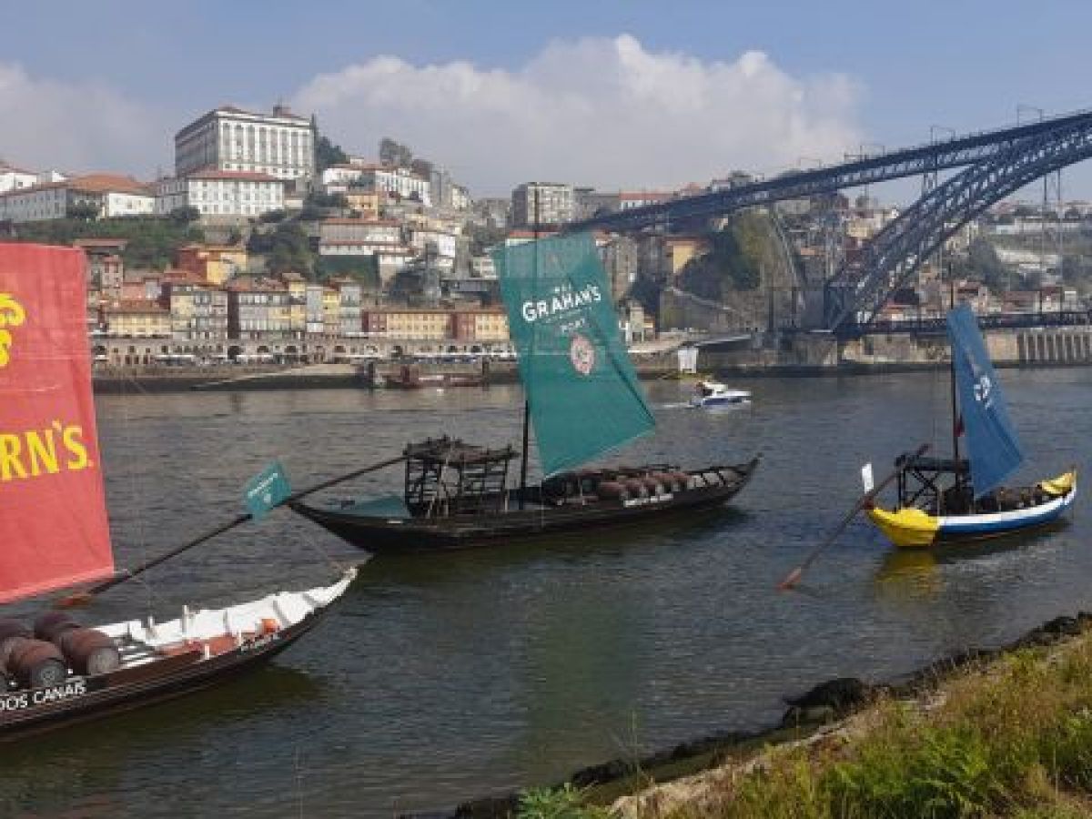 a bridge over a river with a boat in the water