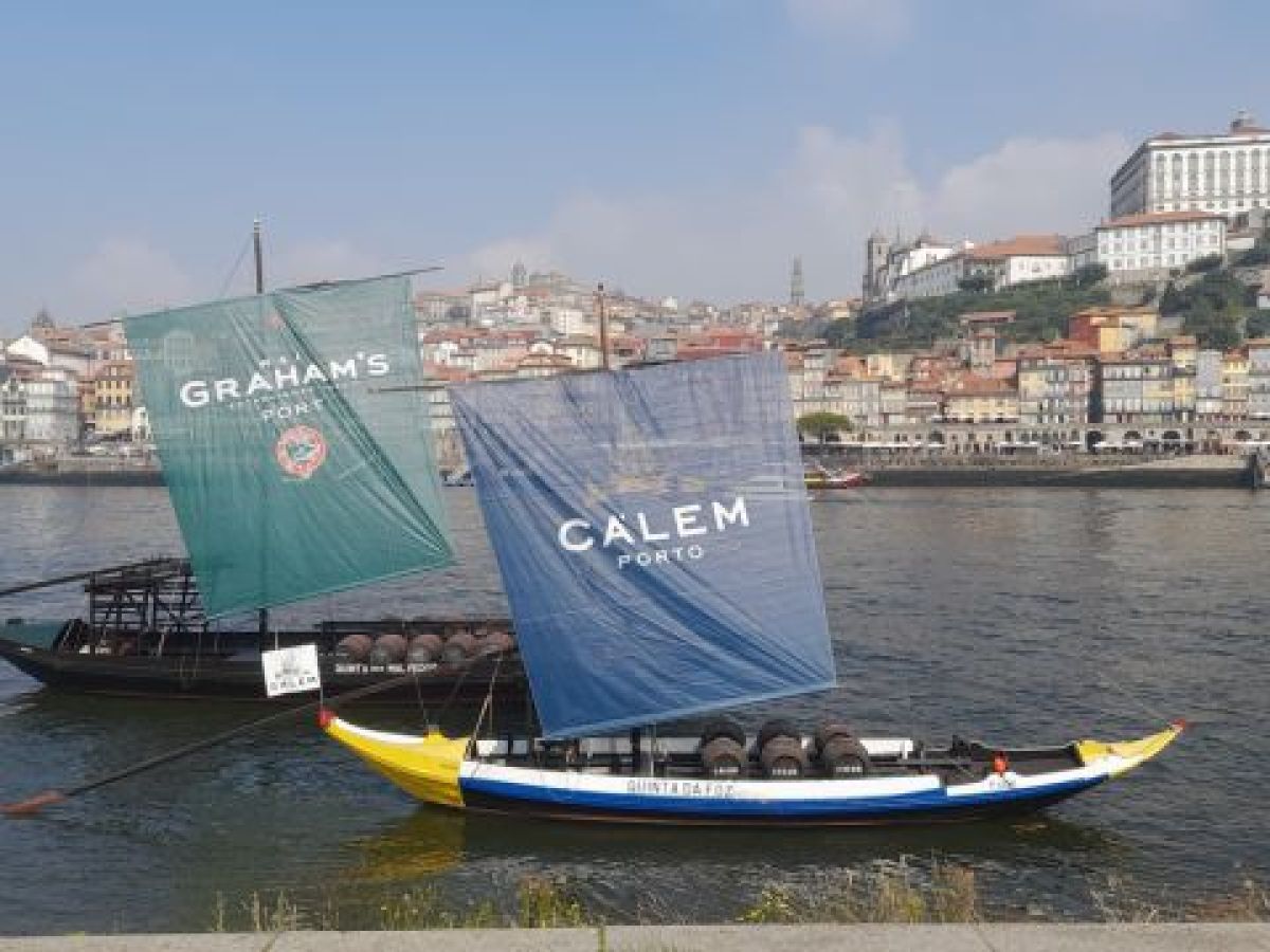 Two sailboats on the water near a city, capturing the essence of a 7-day tour in Porto, Portugal.