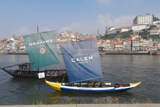 Two sailboats on the water near a city, capturing the essence of a 7-day tour in Porto, Portugal.