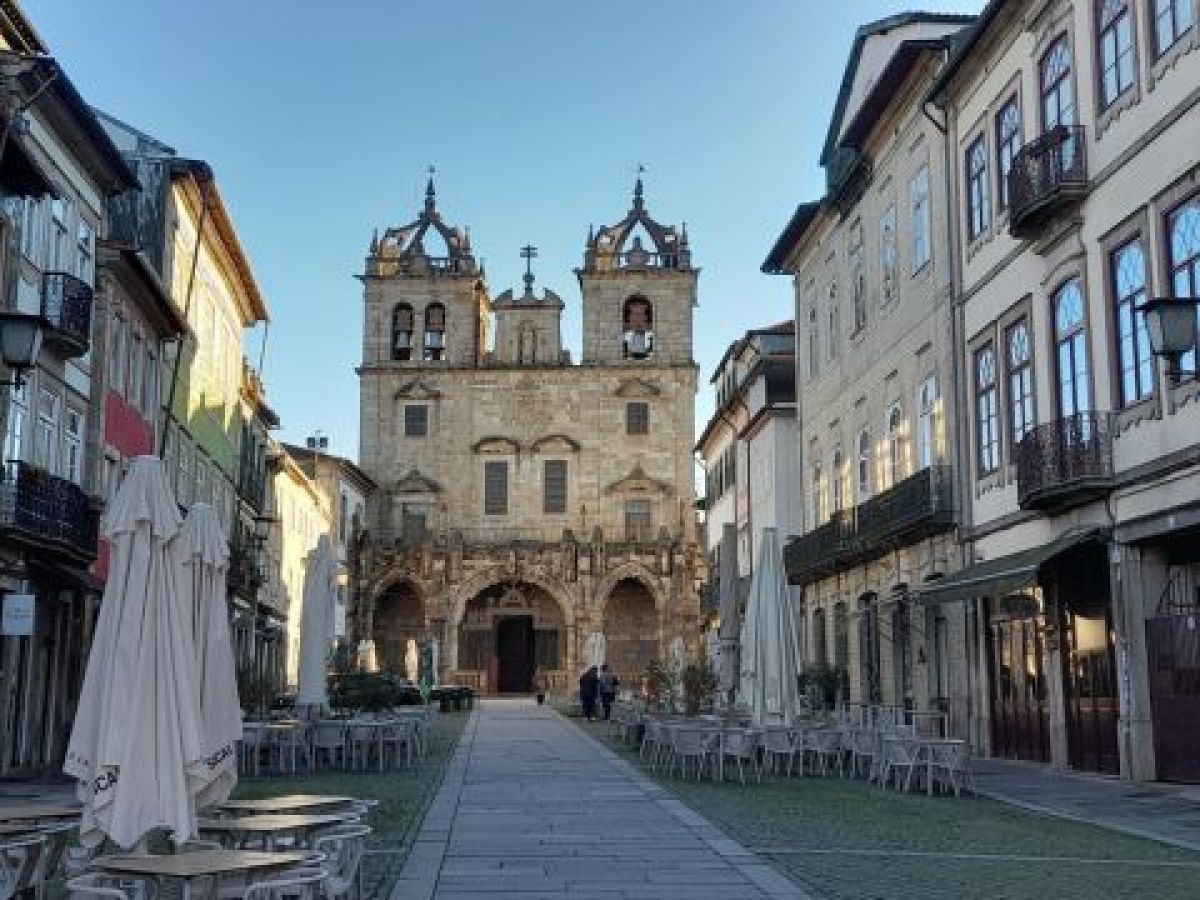a group of people walking in front of a building