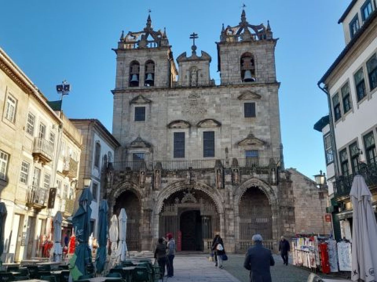 a group of people walking in front of a building