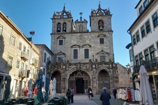 a group of people walking in front of a building