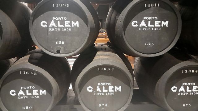 A series of Calem barrels in a wine cellar in Porto highlighting the iconic brand's presence in winemaking