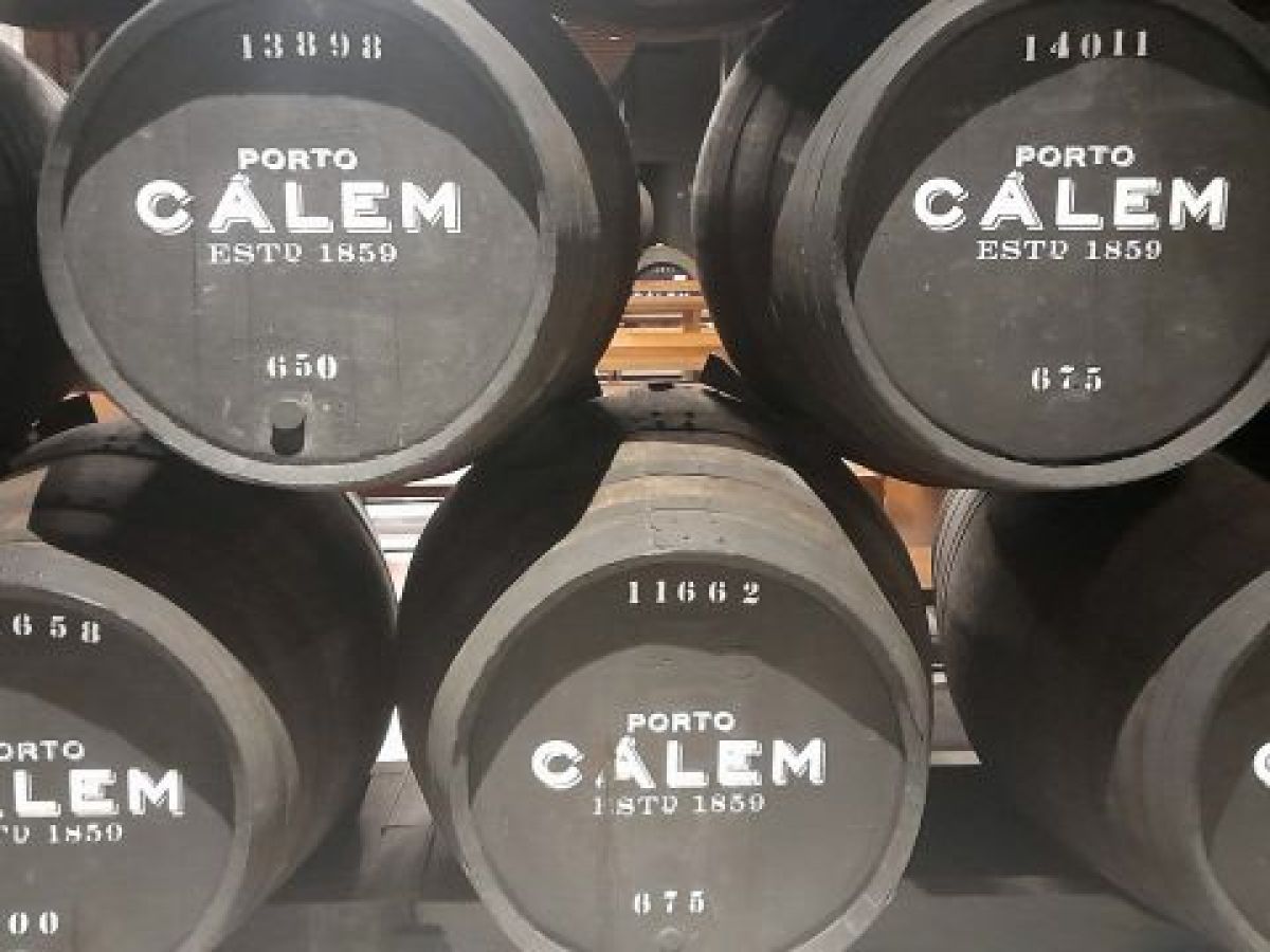 A series of Calem barrels in a wine cellar in Porto highlighting the iconic brand's presence in winemaking