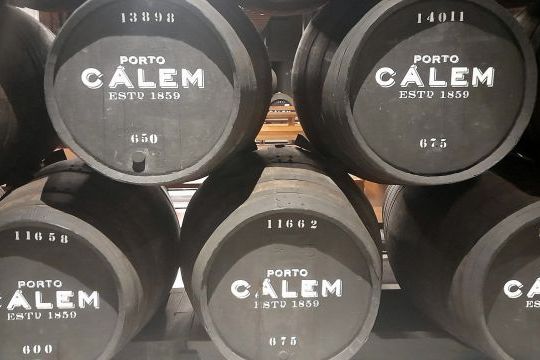 A series of Calem barrels in a wine cellar in Porto highlighting the iconic brand's presence in winemaking