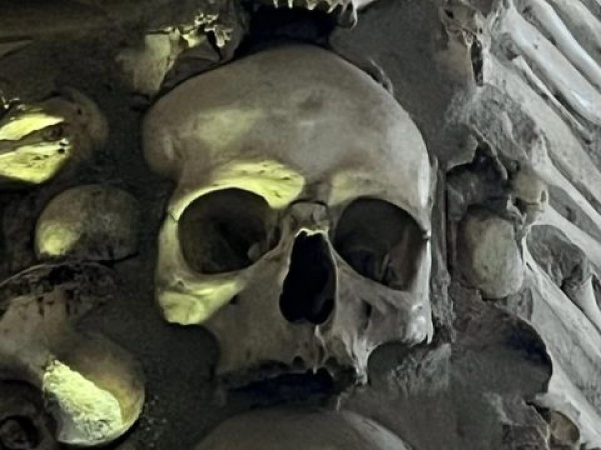 A large pile of skulls in the Chapel of Bones, Evora, Portugal, showcasing a unique and somber historical site.