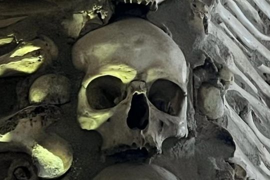 A large pile of skulls in the Chapel of Bones, Evora, Portugal, showcasing a unique and somber historical site.