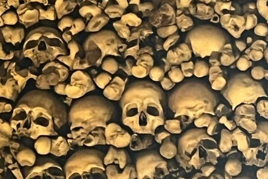 A significant collection of skulls stacked in the Chapel of Bones, located in Evora, Portugal, reflecting its macabre history.